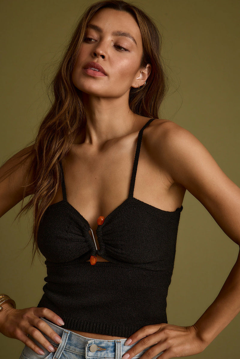 Black knit piece with knit detailing and a flattering silhouette.