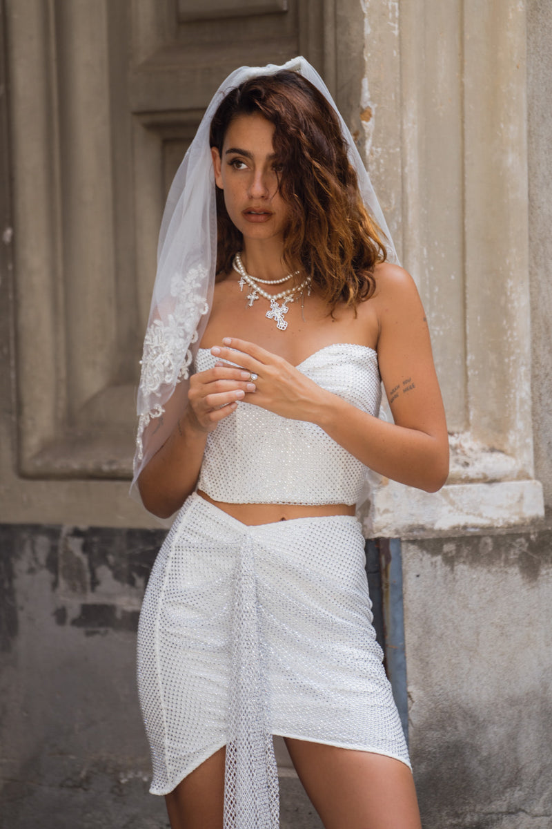 Full-length view of the mini skirt showing the drape and movement.
