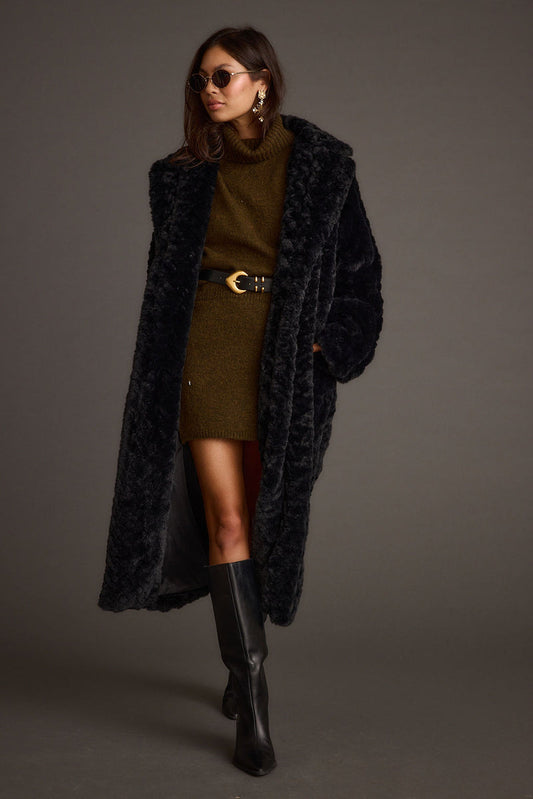 Black jacket with refined detailing and a flattering silhouette.